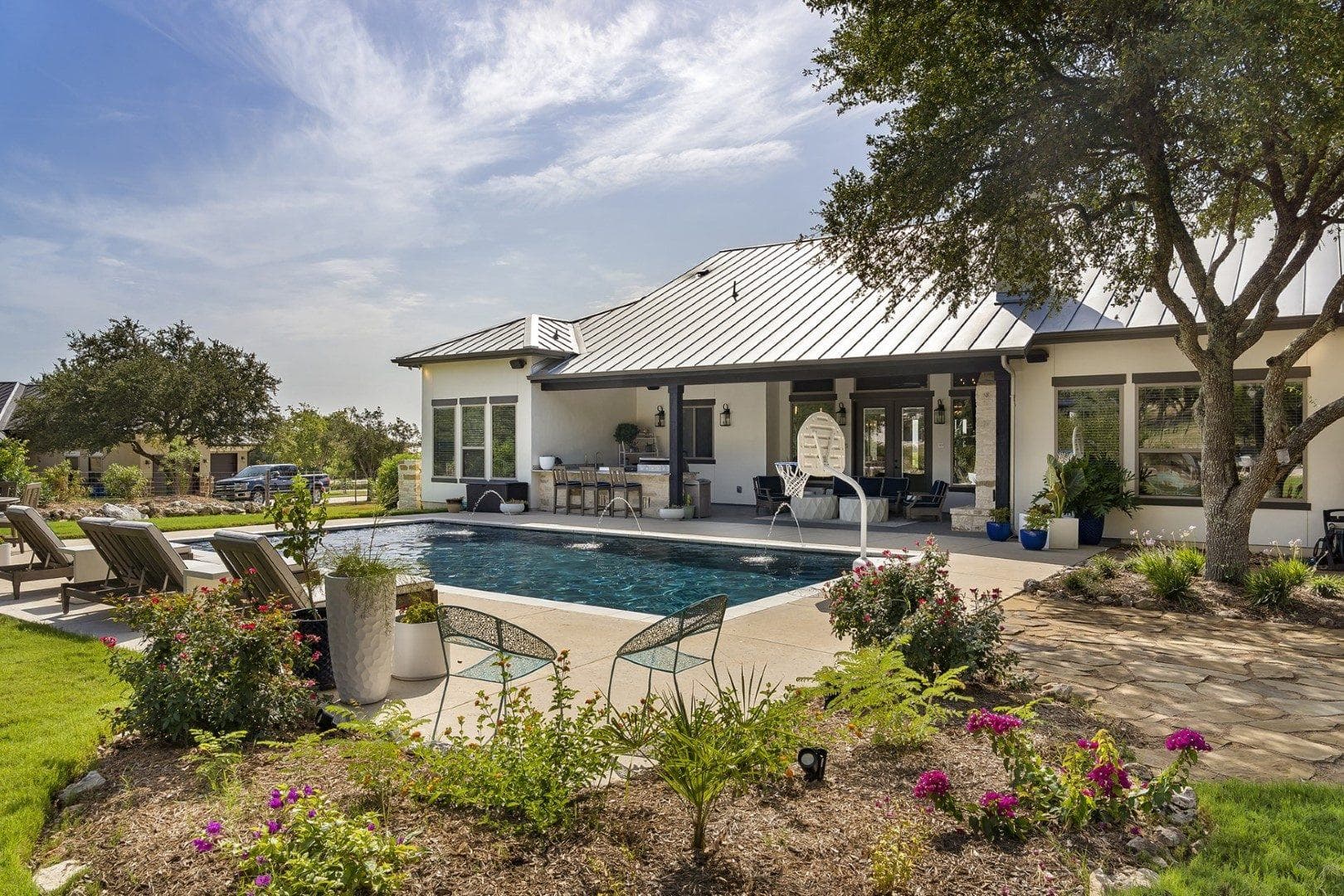 Stone-and-stucco custom home front elevation at dusk