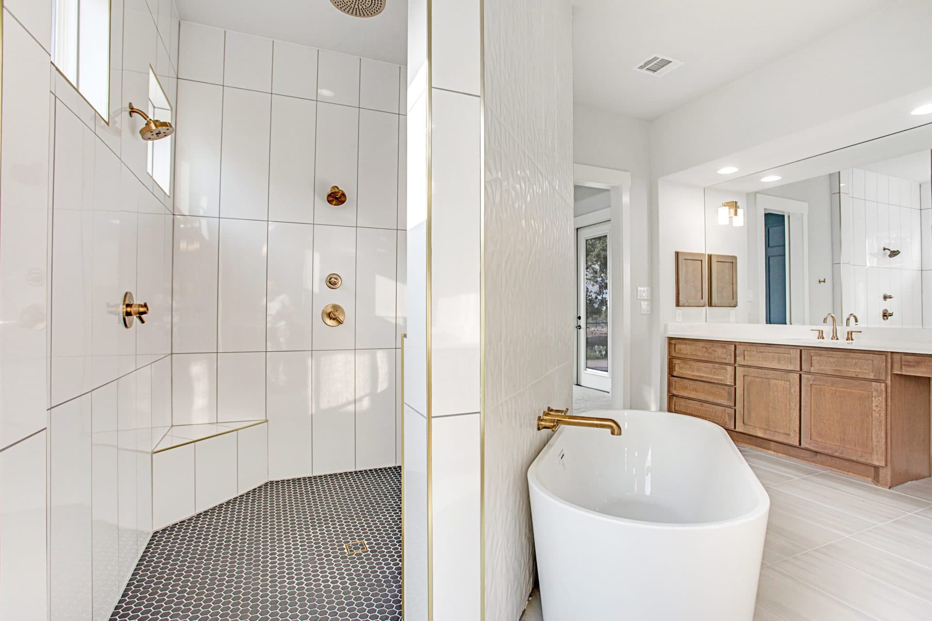 Spa-inspired primary bathroom with a freestanding soaking tub