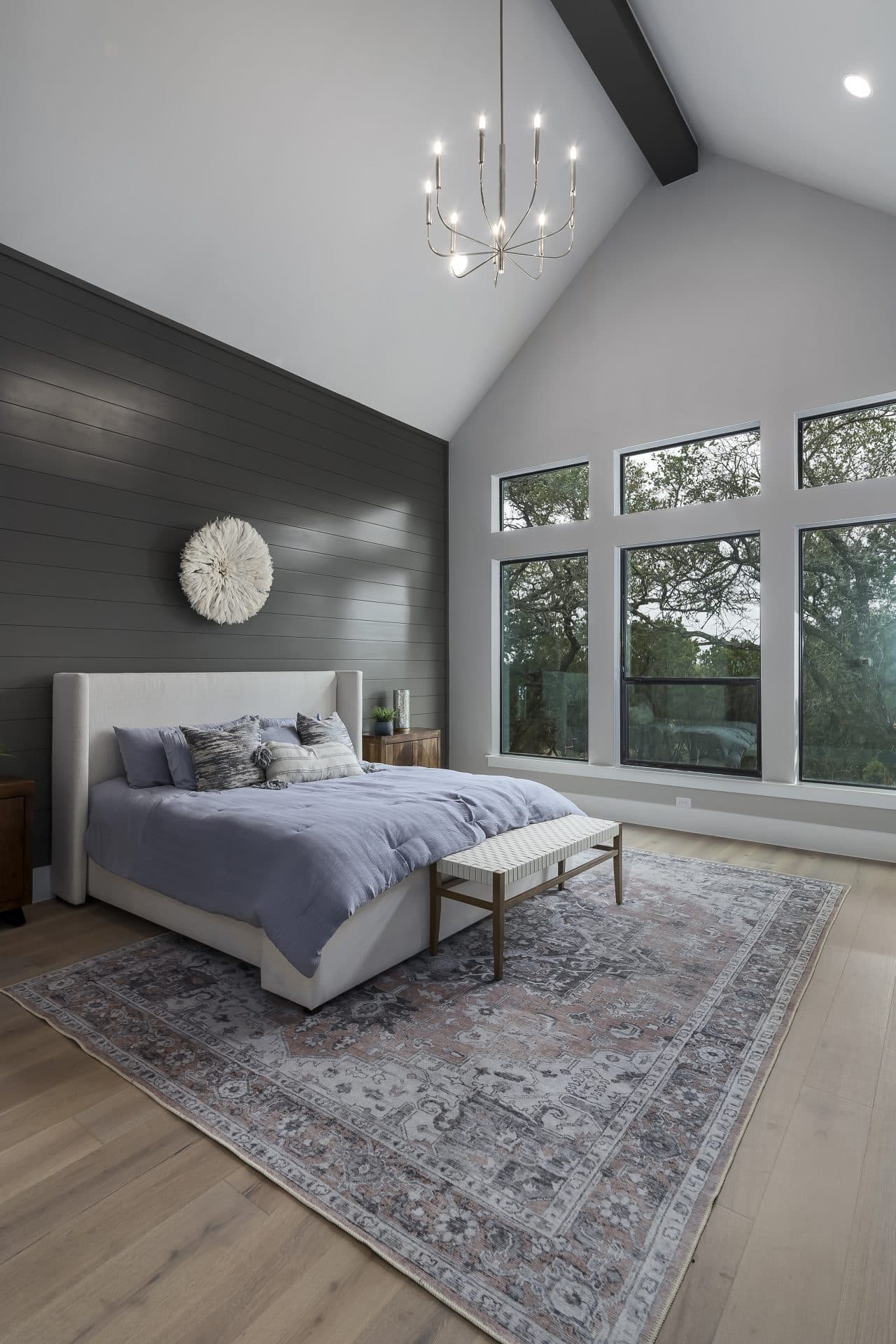 Spacious JLP primary bedroom with a vaulted ceiling and natural light